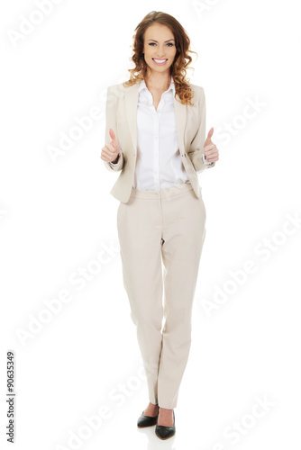 Businesswoman with thumbs up gesture.