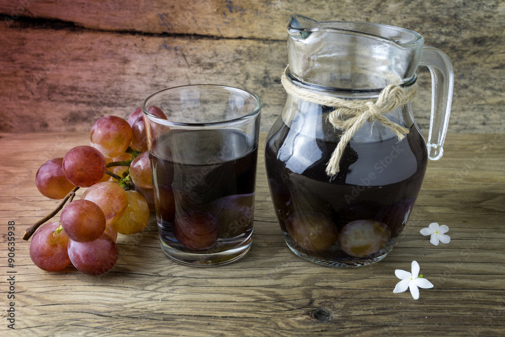 grape compote in a jar on a wooden table