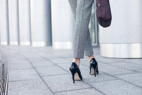 Elegant young businesswoman is going to work photo