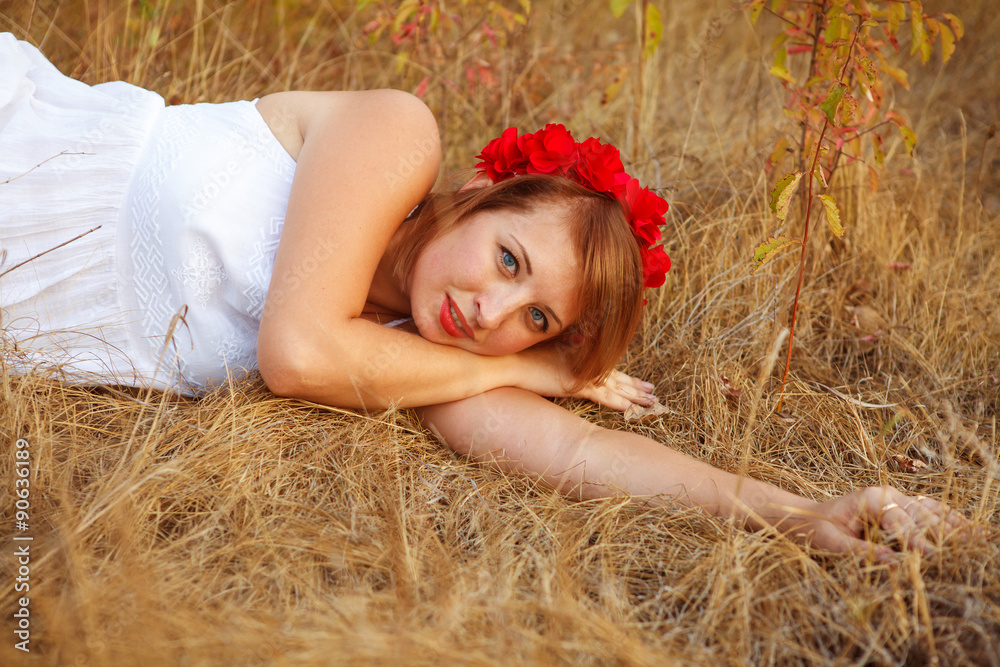 beautiful young woman posing lying in grass outdoors beautiful young woman posing lying in grass outdoors