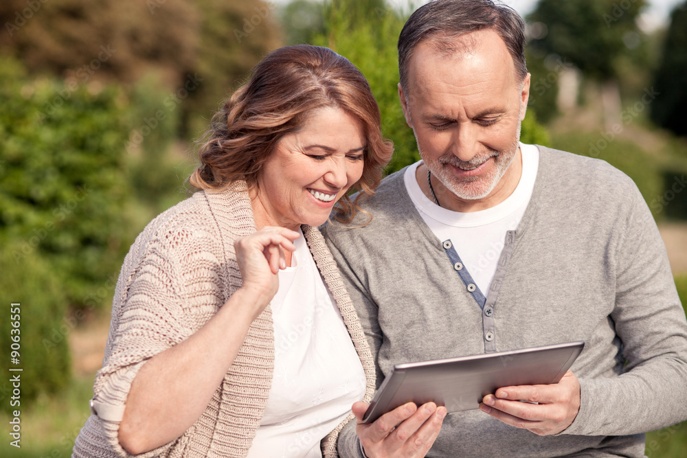 Pretty mature family is using a laptop for fun Pretty mature family is using a laptop for fun