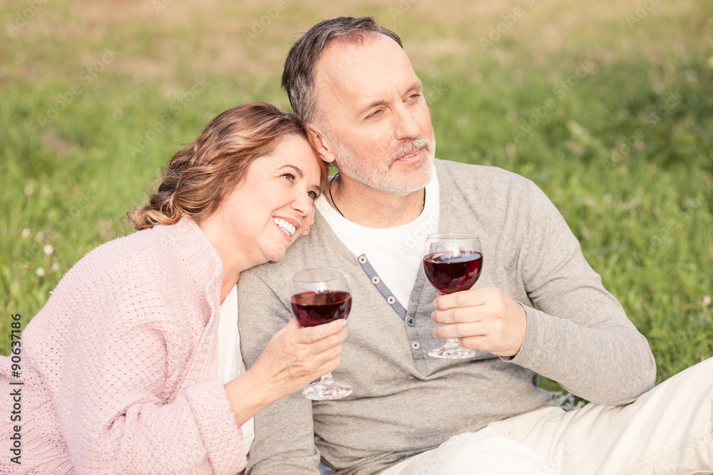 Cheerful old man and woman are resting on grass Cheerful old man and woman are resting on grass