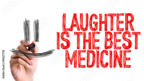 Hand with marker writing the word Laughter is the Best Medicine