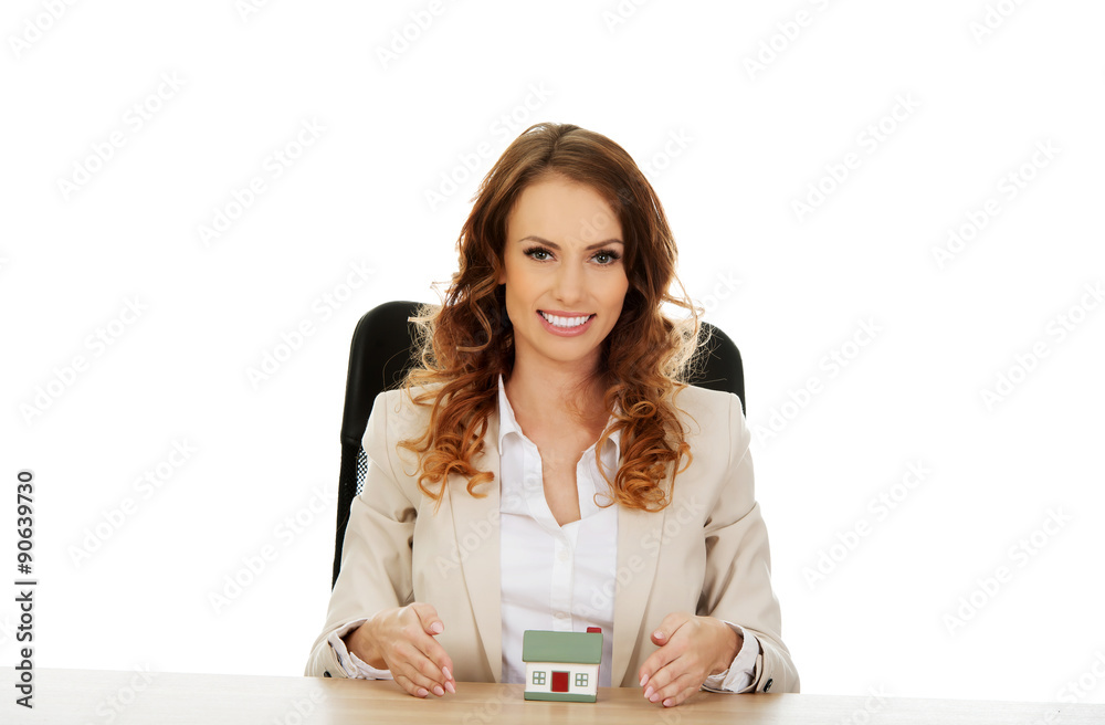 Businesswoman presenting a model house. Businesswoman presenting a model house.