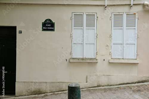 Canvas Print Parisian town house facade with closed shutters made of wood