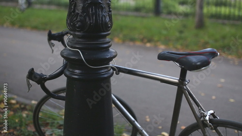 man puts the lock on the bike