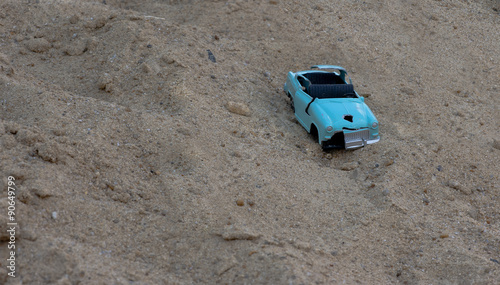 off-road crashed toy motor vehicle driving in the sand
