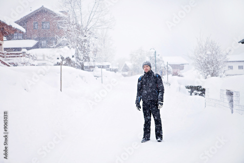 Portrait of young man in snowy village © Tomsickova