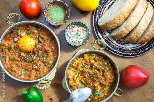 Menemen Turkish breakfast food egg, tomatoes and pepper in pan photo