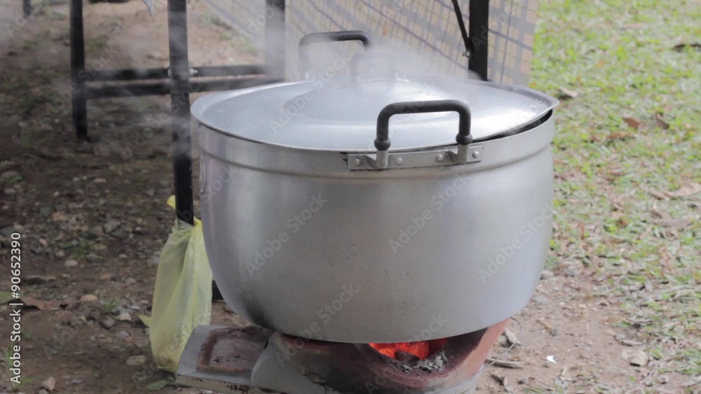 pot with steam on old charcoal brazier, close-up pot with steam on old charcoal brazier, close-up