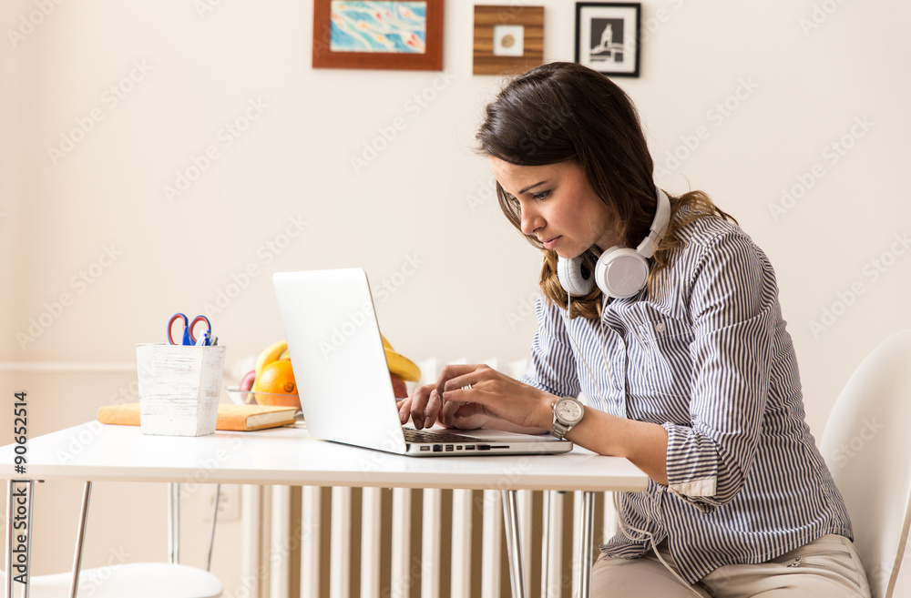 Attractive young woman working on her blog. Attractive young woman working on her blog.