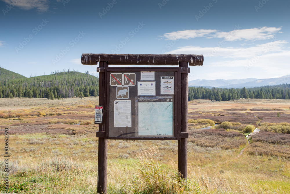 Trailhead sign in landscape setting.