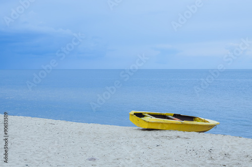 Yellow boat on the sea shore.