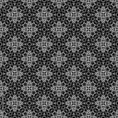 Doodle seamless pattern in black and white. Hand drawn ornamental wallpaper or textile pattern with white calligraphy motives on black background in vector format. 