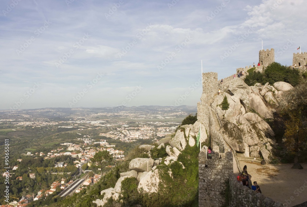 Castle of the Moors in Sintra, Portugal, with people walking in it, and beautiful surrounding landscape