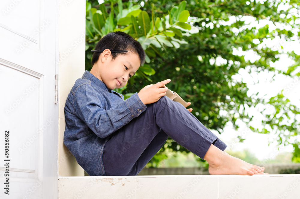 Young boy reading book Young boy reading book