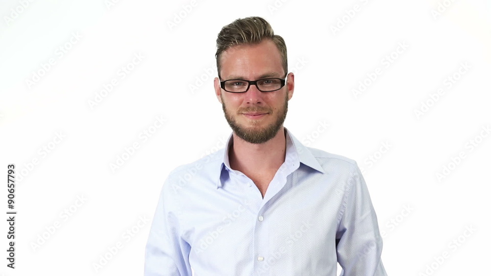 An attractive man wearing a blue shirt and glasses, smiling towards camera. White background. An attractive man wearing a blue shirt and glasses, smiling towards camera. White background.
