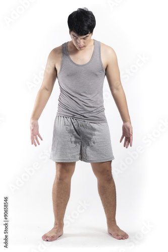 Valokuva Asian man in grey pajamas with wet crotch