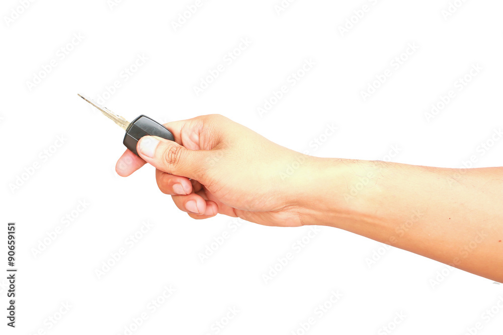Male hand holding car key isolated on white background Male hand holding car key isolated on white background