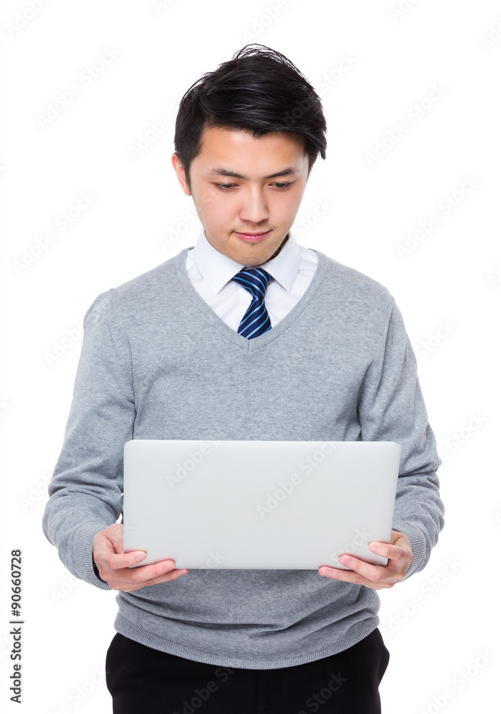 Young businessman read on the notebook computer Young businessman read on the notebook computer