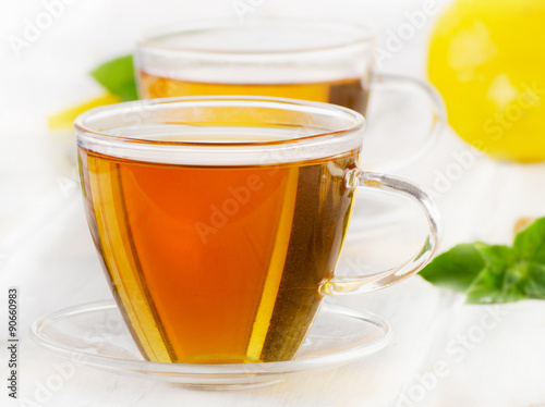 Hot tea with mint leaves and lemon slices.