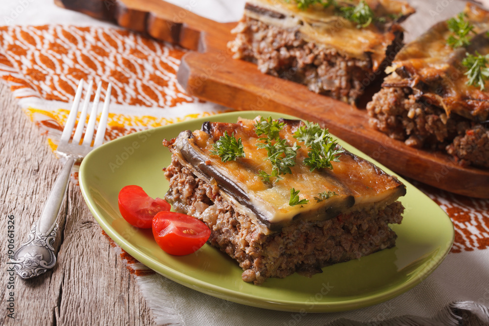 Portion of moussaka with eggplant on a plate close-up. horizontal
Portion of moussaka with eggplant on a plate close-up. horizontal