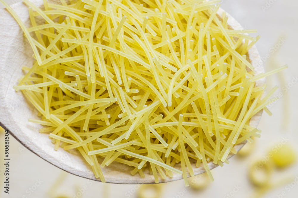 Vermicelli pasta poured from a spoon Vermicelli pasta poured from a spoon
