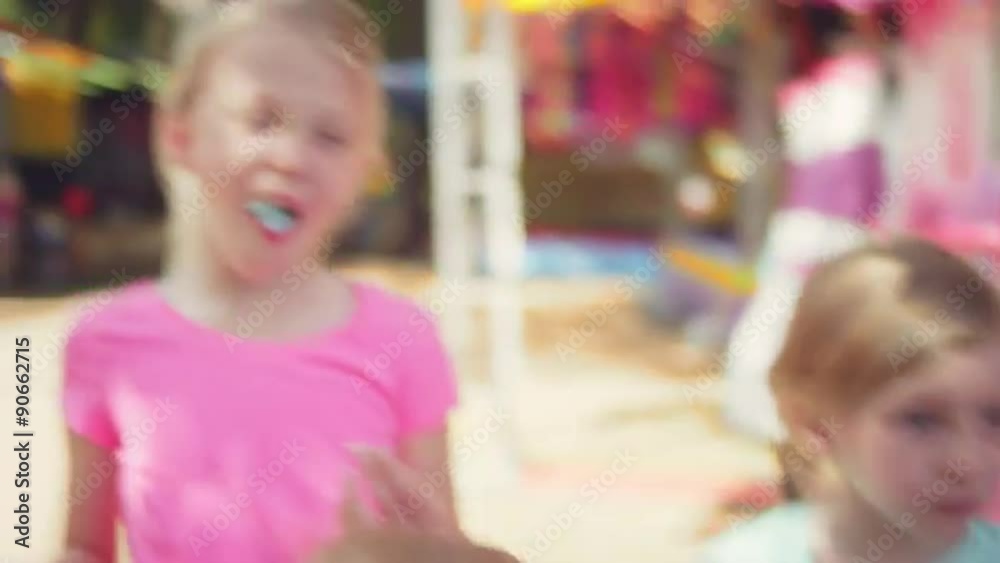 Three little girls eating cotton candy at a fair
Three little girls eating cotton candy at a fair
