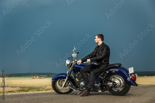 Man resting on motorcycle