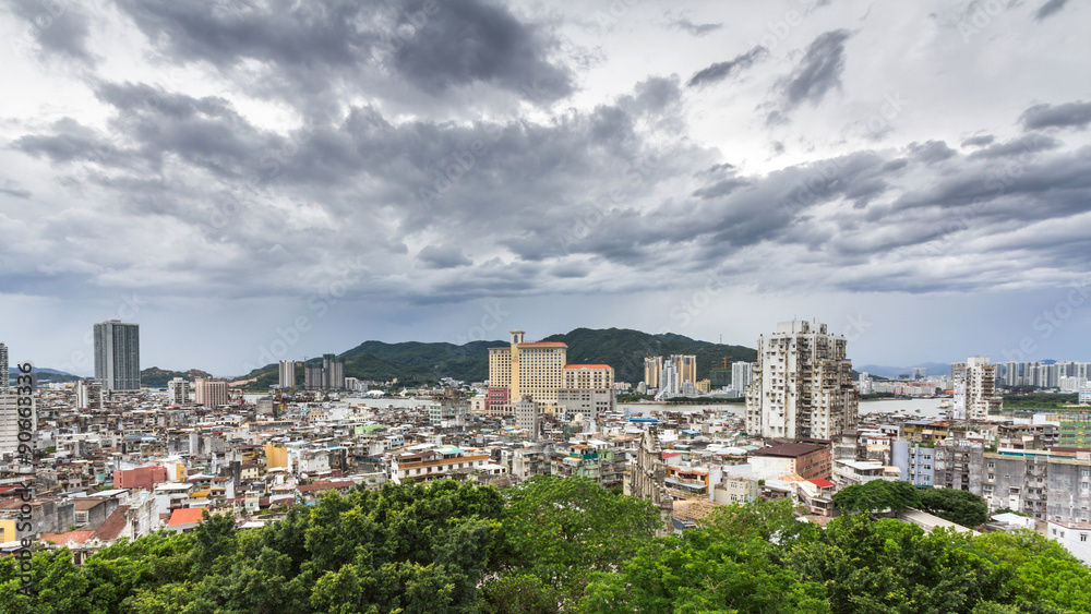 Obraz premium Macau packed houses and city skyline under the cloudy sky. Rich and poor stays close to each other in Macau, China.
