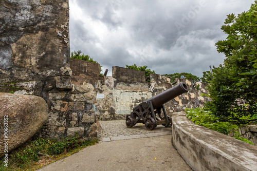 Cannon guarding the battlements of ancient Monte Fort in Macau, China  photo