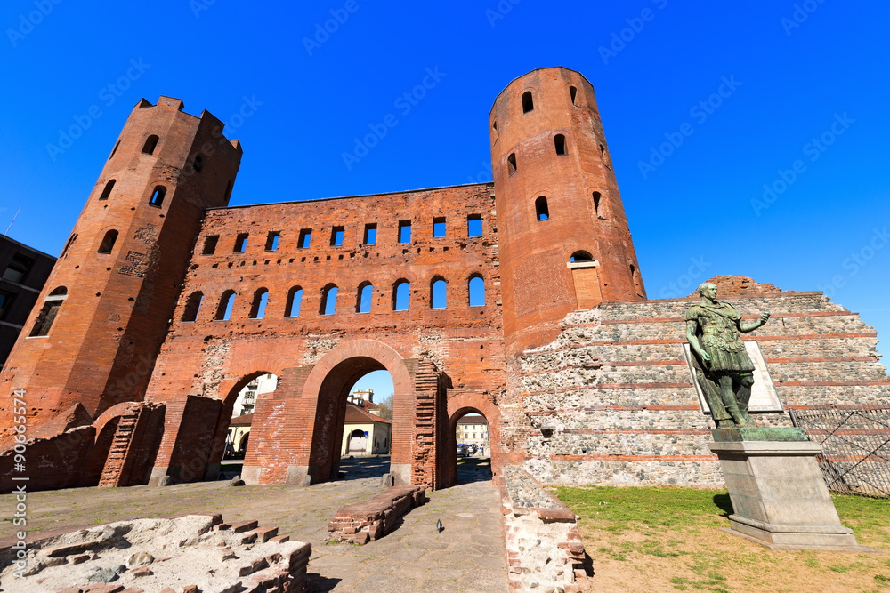 Porta Palatina - Torino Italy / Roman statue of Julius Caesar and ancient ruins of Palatine Towers in Torino, Piemonte, Italy