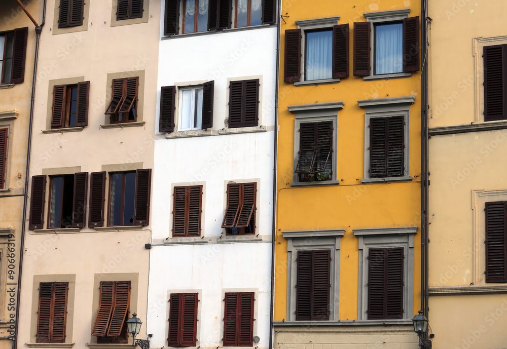 Windows and balcony of a building in a historic Italian square