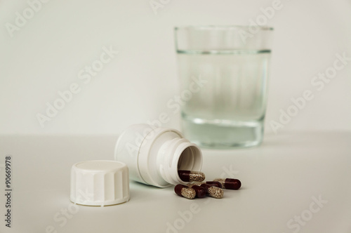 heap pills and glass of water  photo