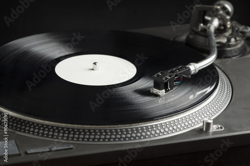 Turntable playing vinyl close up with needle on the record