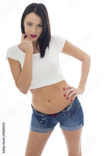 Sexy Young Caucasian Woman Wearing a White Vest Top and Blue Denim Shorts © Martin Lee