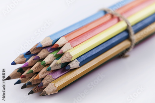 Colored pencils on white background photo