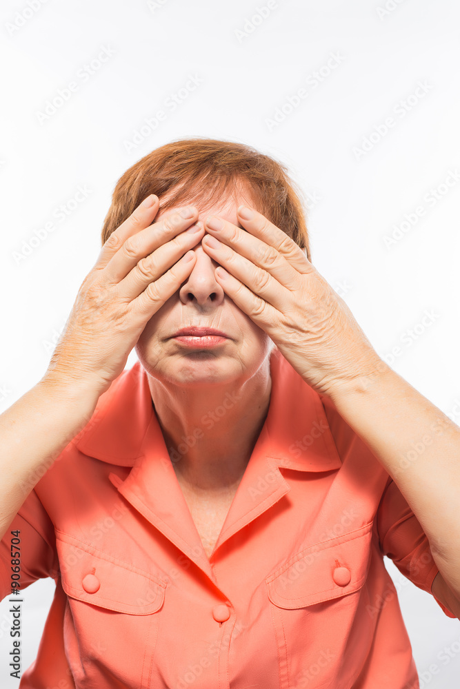 old woman covering her eyes with her hands