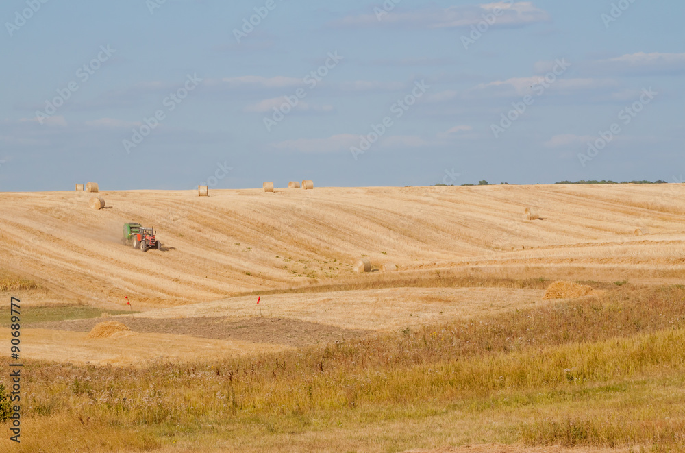 Tractor collecting straw