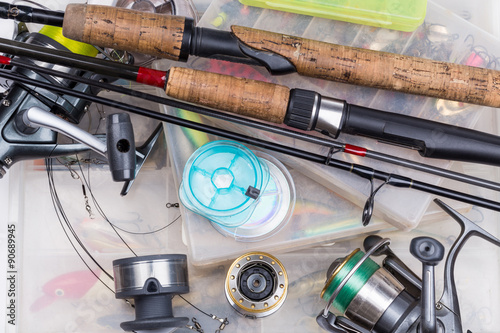 fishing tackles - rod, reel, line and lures in box