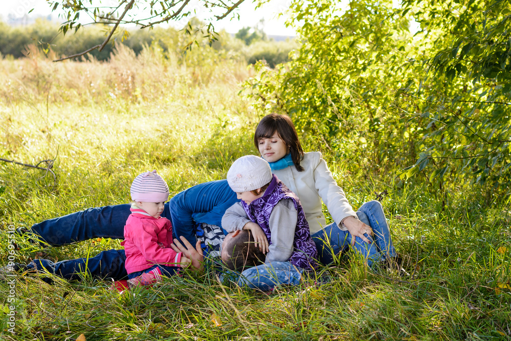 Fototapeta premium Family resting the meadow in autumn