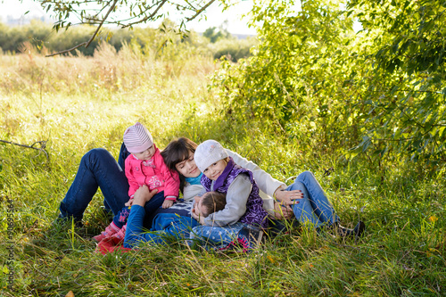 Family resting the meadow in autumn