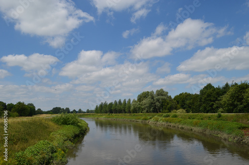 Large river with green shores in flanders