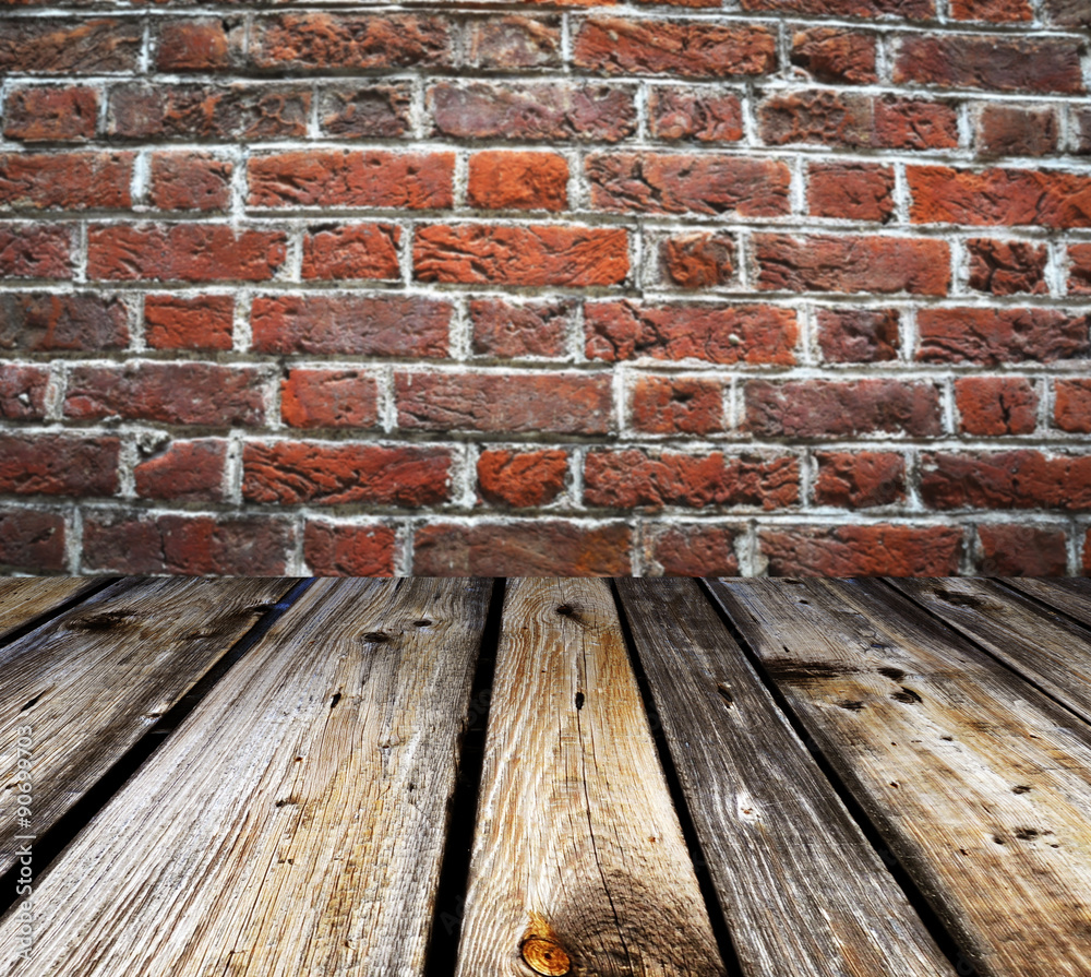 Wooden planks with brickwall in the background