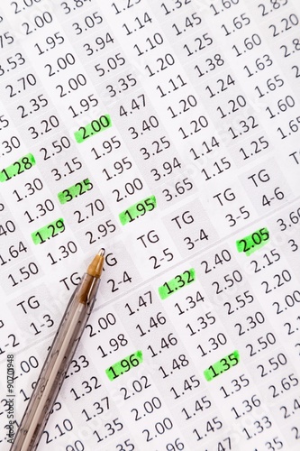 Odds for betting and a ballpoint for notes