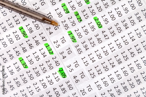 Odds for betting and a ballpoint for notes