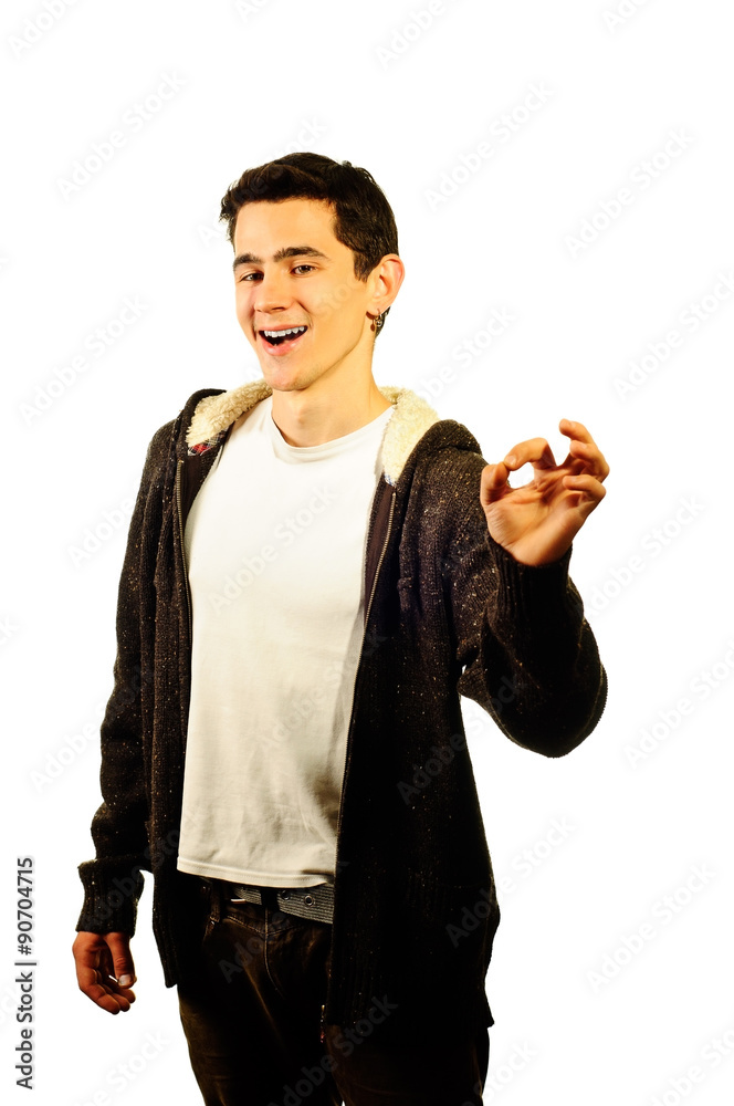 A happy guy in a warm sweater showing ok gesture isolated on white A happy guy in a warm sweater showing ok gesture isolated on white