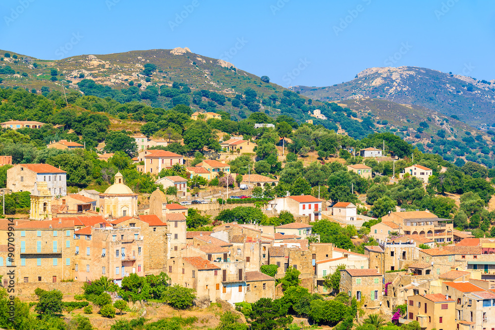 View of Cateri village with stone houses built in traditional Corsican style on top of a hill, Corsica island, France