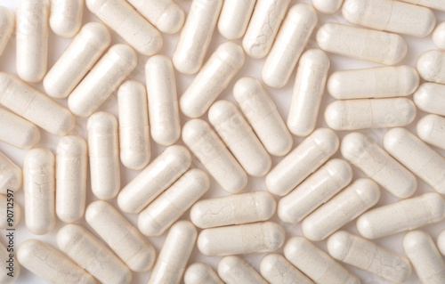 Medical background with white capsules photo