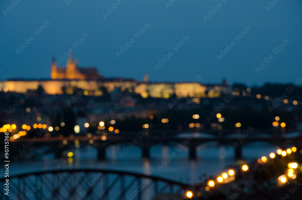 Castle and cathedral out of focus above river with bridges
